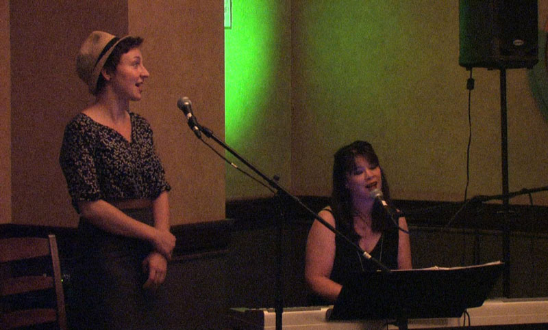 Brittany Gillstrap and Angela Predhomme sing together