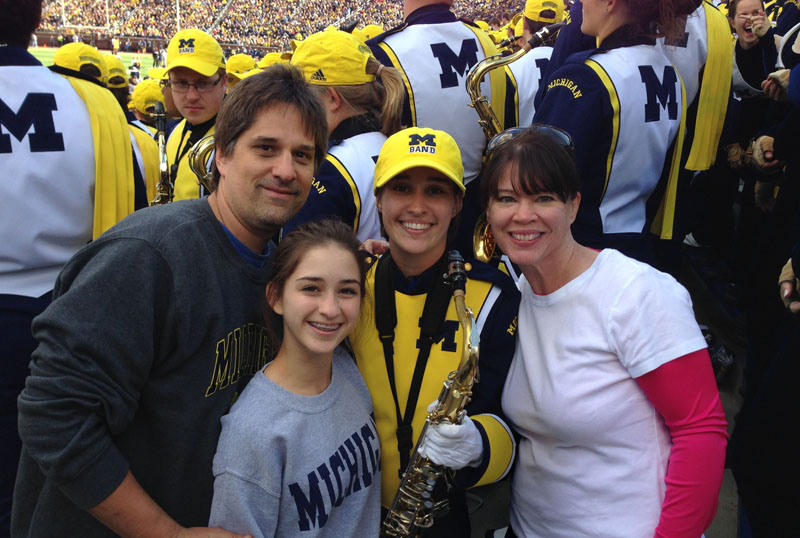 with UM marching band member in the stands at a football game